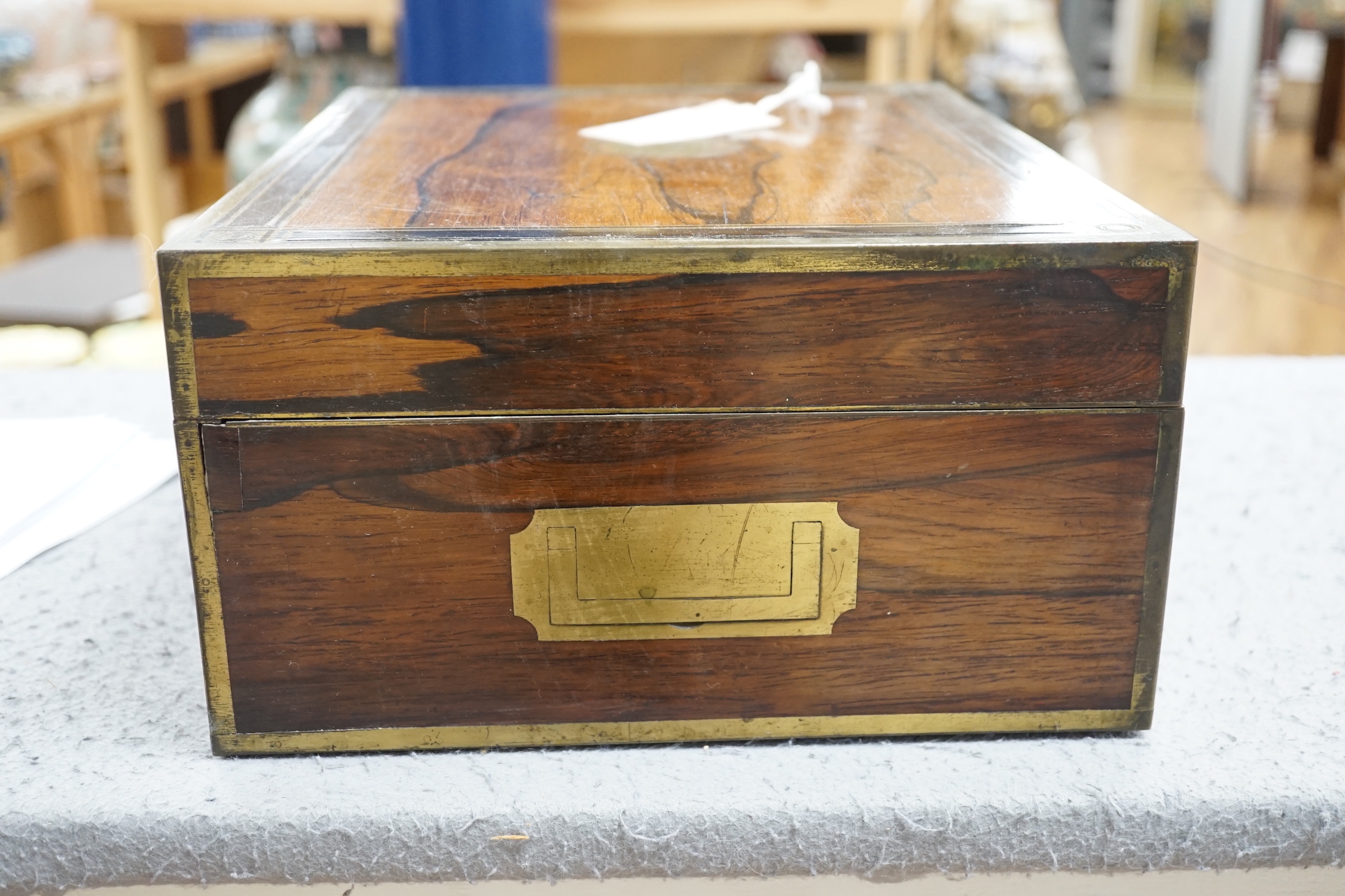 A George IV brass mounted rosewood travelling toilet box, with eleven silver mounted glass toilet jars etc, John & Archibald Douglas, London, 1822, with engraved monograms, four caps unmarked, box 34.1cm.
